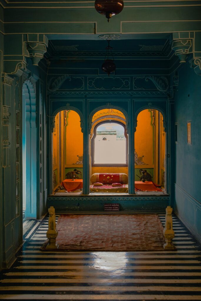 Elegant depiction of ornate interior design in a historical Udaipur palace with vibrant colors.